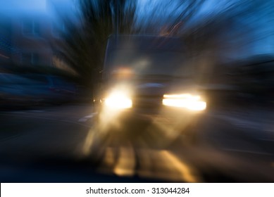 A van approaching in a menacing way in twilight, with deliberate camera shake for the concept of car accident risks