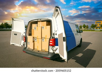 Van With Cardboard Boxes. Delivery Service Van Back View. Courier Van With Open Rear Doors. Courier Service Car. Minivan For Move. Boxes For Moving In Truck. Concept - Renting Minivan For Moving.