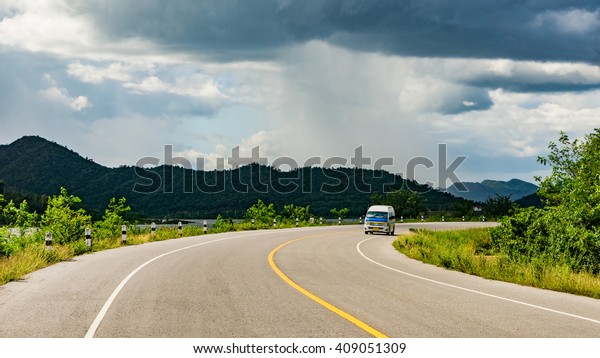 A van driver driving so fast , trying to escape from\
thunderstorms 