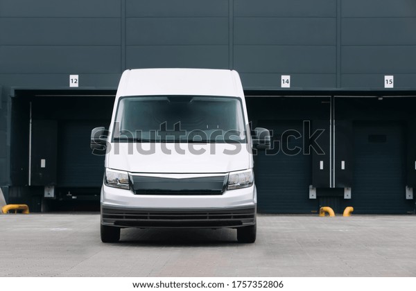 Van\
in front of cargo warehouse and logistic center. The Cargo bus is\
waiting for loading. Delivery minivan ready for\
route