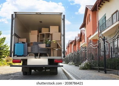 Van Full Of Moving Boxes And Furniture Near House