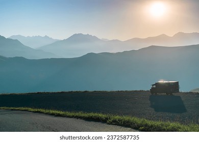 A van installed in front of a mountainous landscape