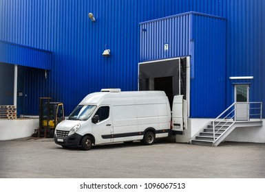 Van In Loading And Unloading Commercial Cargo In Warehouse Dock