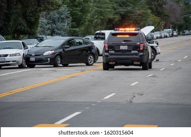 Van Nuys, California / USA  - January 19, 2020: A LAPD Traffic Patrol Vehicle Sits In The Middle Of The Road At A Traffic Accident Investigation Near Witnesses And Drivers In Front Of 6750 Balboa Blvd