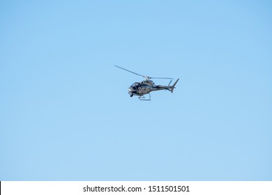 Van Nuys, California / USA -  September 22, 2019: AS350 Eurocopter with camera pod and surveillance gear landing at Van Nuys Airport (KVNY).