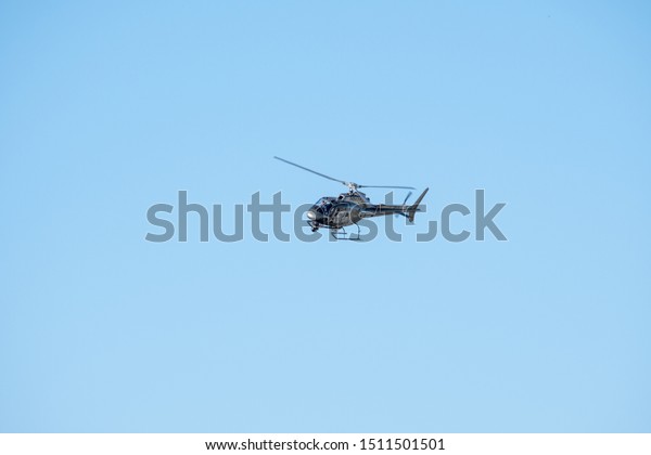 Van Nuys, California / USA -  September 22, 2019:\
AS350 Eurocopter with camera pod and surveillance gear landing at\
Van Nuys Airport (KVNY).