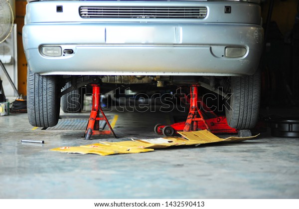 Van on hydraulic\
car jack with jack stand.