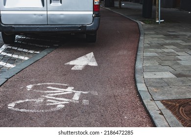 Van Parked On A Bicycle Lane Due To Road Mark And White Arrow On Asphalt Next To A Paved Sidewalk. Breaking Law Concept