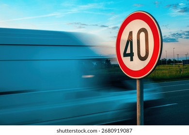 Van speeding by the speed limit traffic sign, motion blur image with selective focus
