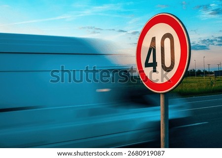 Van speeding by the speed limit traffic sign, motion blur image with selective focus