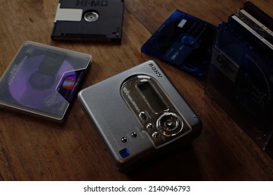 Vancouver, BC, Canada- 03 26 2022: View Of A Sony Walkman Mini Disc Player Surrounded By Mini Discs On A Wooden Table With Focus On The Walkman Logo.