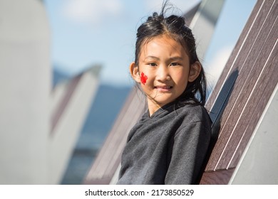 Vancouver, BC, Canada, 7 01 2022, A Beautiful Indigenous Girl With A Flag On Her Cheek During The Canada Day Celebrations In Downtown