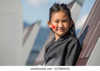 Vancouver, BC, Canada, 7 01 2022, A Beautiful Indigenous Girl With A Flag On Her Cheek During The Canada Day Celebrations In Downtown