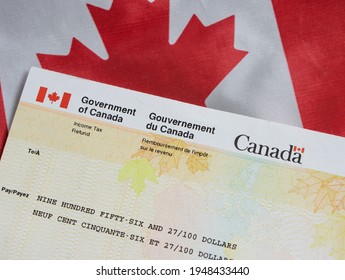 Vancouver, BC - Canada - April 02, 2021: Canada Government Tax Refund Cheque, CRA Benefit With Canada Flag Background