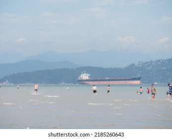 Vancouver, BC Canada - August 1, 2022: People Enjoying Cooler Temperatures At The Beach After The Heatwave On BC Day In Vancouver.