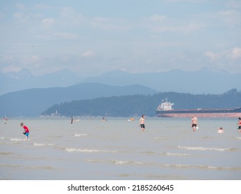 Vancouver, BC Canada - August 1, 2022: People Enjoying Cooler Temperatures At The Beach After The Heatwave On BC Day In Vancouver.