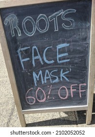 Vancouver BC Canada, August 2021: Sign Displaying A Sale On Covid Facemasks For Protection Against The Pandemic, Before The Omicron Variant Increase In Cases, End Of The Pandemic Was In Sight.