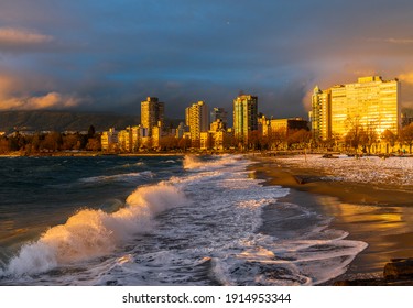 Vancouver BC Canada. February 2021. English bay beach strong wave with orange sunset lights effect backgrounds