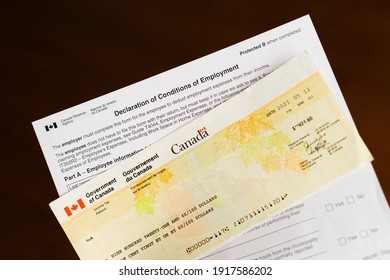 Vancouver, BC | Canada - February 2021: Government Home Office Employees Expenses Form With Benefit Cheque