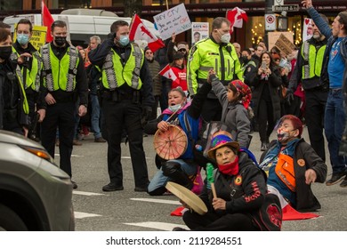 Vancouver, BC, Canada, February 5, 2022, The Indigenous People With Children In The Burrard Street With The Drum, Actively Protesting Against Mandates, Surrounded By Police