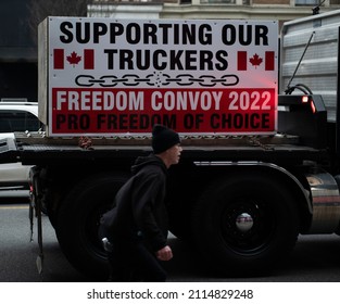 Vancouver, BC Canada January 29 2022: Anti vaccine convoy vehicle protest downtown on Burrard. Signs, flags, banners flying from cars and trucks, anti-mandate, "freedom convoy", anti-lockdown and mask