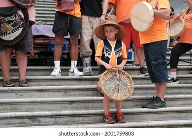 Vancouver, BC, Canada - July 1, 2021: Young boy stands on the steps of the Vancouver Art Gallery at a "Cancel Canada Day" rally in reflection of the Canadian Residential School System 