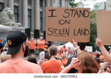 Vancouver, BC, Canada - July 1, 2021: "I Stand on Stolen Land" sign is held at a "Cancel Canada Day" rally in reflection of the Canadian Residential School System 
