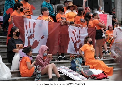 Vancouver, BC, Canada - July 1, 2021: First Nations Children Hold A Critically Stylized Canadian Flag At A 