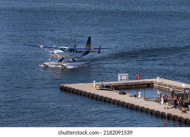 Vancouver BC Canada July 2022, A Sea Plane Is Landing And Back To The Dock.