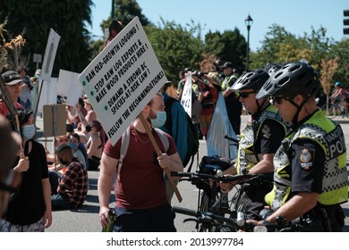 Vancouver, BC, Canada - July 24, 2021:  Activist confronts a police officer at an "Extinction Rebellion" climate change protest in front of the Burrard Street Bridge