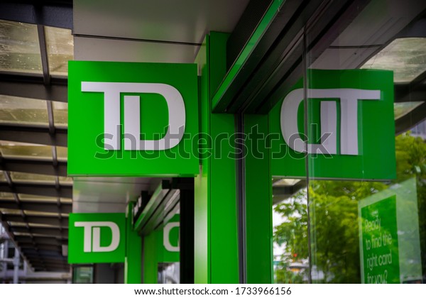Vancouver, BC / Canada - May 17th 2020: a close-up\
shot of the green TD Bank logo at a TD Branch located in the hip\
neighborhood of Olympic Village in Vancouver Canada  - One of the\
big Canadian Banks