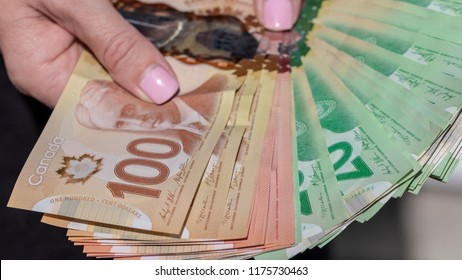 Vancouver, BC / Canada - September 8th 2018 : A Hand Holding a Bunch of Canadian Cash