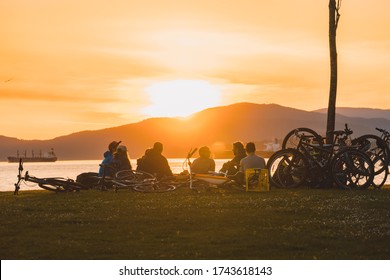 Vancouver BC Canada,April 2020.group Of People Sitting Together On Beach With Sunset Backgrounds During The Covid_19
