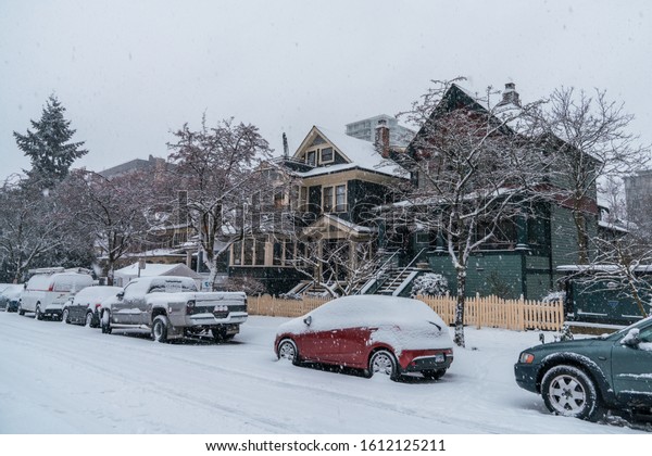 Vancouver BC Canada,February 2019.Vancouver\
city house and cars with snow\
backgrounds