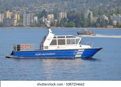 VANCOUVER, BC/Canada - May 8, 2018: Profile view of the Vancouver Fraser Port Authorities with North Vancouver in the background as they head into Vancouver, Canada's harbor on May 8, 2018.