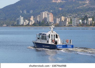 VANCOUVER, BC/Canada - May 8, 2018: A Vancouver Fraser Port Authority boat in Vancouver, Canada heads out into English Bay where it will help ships navigate entering the harbor on May 8, 2018.