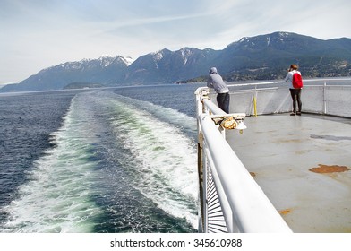 Vancouver British Columbia Canada - April 21 2012  Ferry crossing to the island . Travel commuters  on deck scenery of the mountains and waves