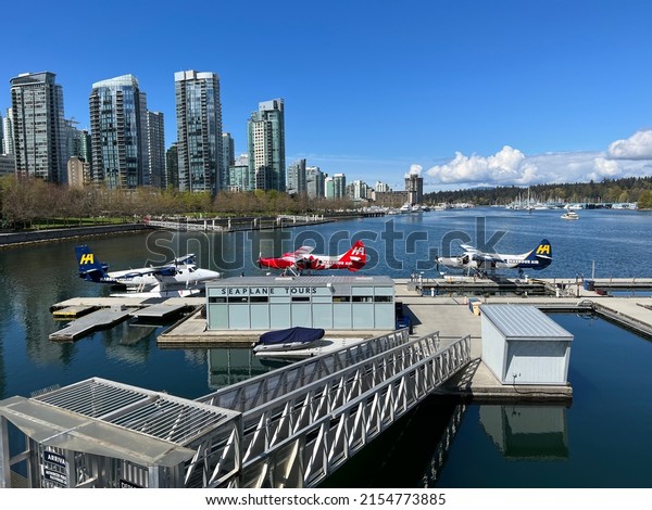 Vancouver, British Columbia, Canada - April 25,\
2022: Vancouver waterfront and Harbour Air Seaplanes port.\
Seaplanes at Vancouver Harbour Flight\
Centre.