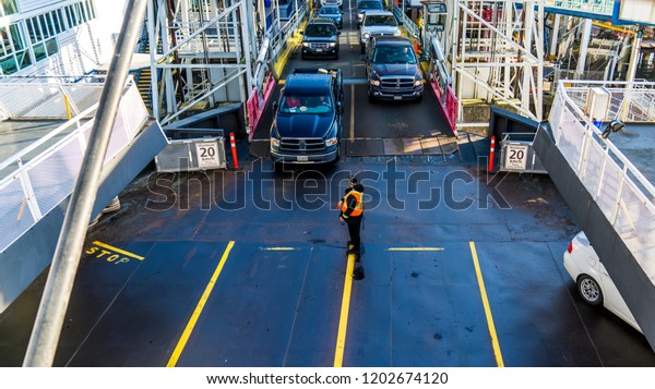 Vancouver, British Columbia -\
Canada. Cars being loaded on a ferry. Beautiful British Columbia,\
Canada.
