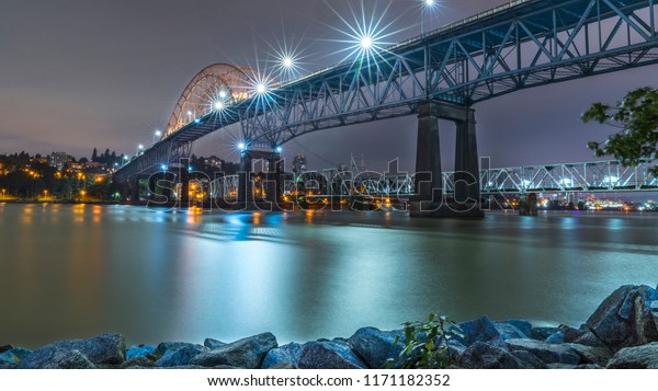 Vancouver,\
British Columbia - Canada. Pattullo Bridge, Surrey to New\
Westminster. Long exposure of the bridge over the water. Sky Train\
Bridge.\
Beautiful British Columbia,\
Canada.