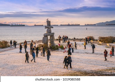 Vancouver British Columbia Canada,January 2017. People Visiting Inukshuk Vancouver At English Bay Beach,Canada