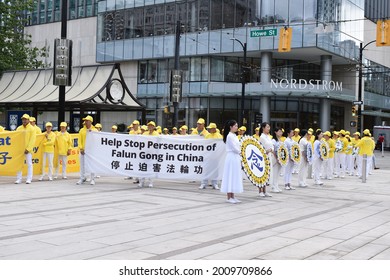 Vancouver,, British Columbia, Canada-July 17, 2021:  Demonstrators Holding A Sign To Help Stop The Persecution Of FalunGong In China In Front Of The Vancouver Art Gallery.