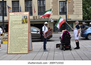 Vancouver, British Columbia, Canada-July 17, 2021:  Demonstrators Across From The Hotel Georgia In Vancouver Beside A Sign Detailing Maryam Rajavi's Ten Point Plan For A Future Iran.