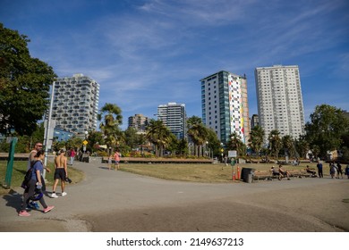 Vancouver, Canada 08.16.2021 - English Bay Coast Beach, People Walking On Sport Trail In Downtown. Apartments