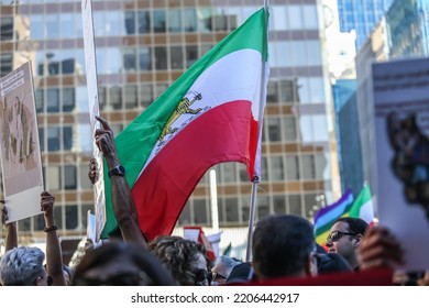 Vancouver, Canada, 9 25 2022: The Flag Of Iran Among The Blurry Crowd Of The Protesters Against Islamic Republic And Iranian Regime And A Murder Of  Mahsa Amini