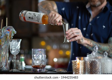 VANCOUVER, CANADA - Aug 09, 2019: Bartender Making Pouring Alchohol Into Shot Glass At Cocktail Bar Drinks In Restaurant