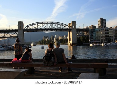 VANCOUVER, CANADA - Jul 30, 2021: The people enjoying the view of Burrard Street Bridge over the ocean in Vancouver, Canada