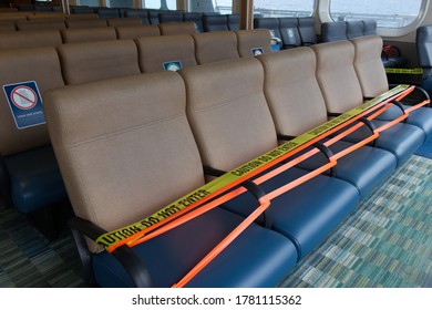 Vancouver, Canada - July 16,2020: Physical distancing concept. BC Ferries workers keep space between seats to avoid spreading COVID-19 on board