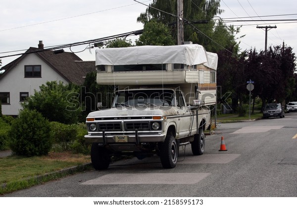 VANCOUVER, CANADA - Jun 30,\
2021: An old van parked in the street in Burnaby, British Columbia,\
Canada