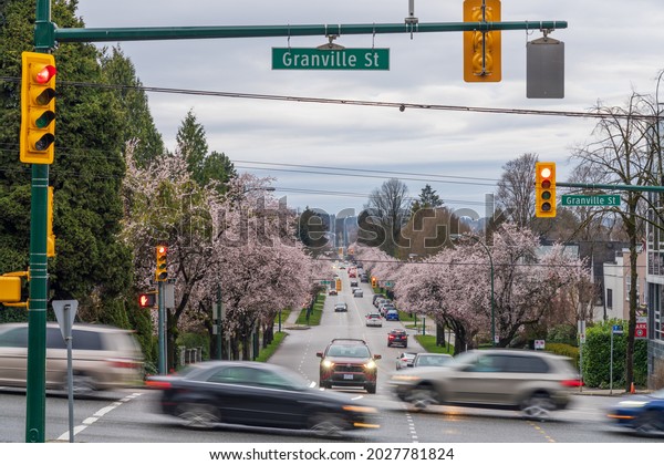 Vancouver, Canada - MAR 20 2021 : Vancouver City in\
cherry blossom season. Granville Street and West 16th Avenue in\
spring time.
